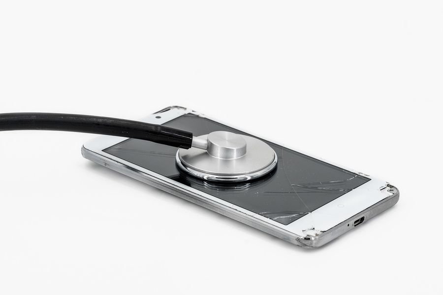 Cracked smartphone being assessed with a stethoscope