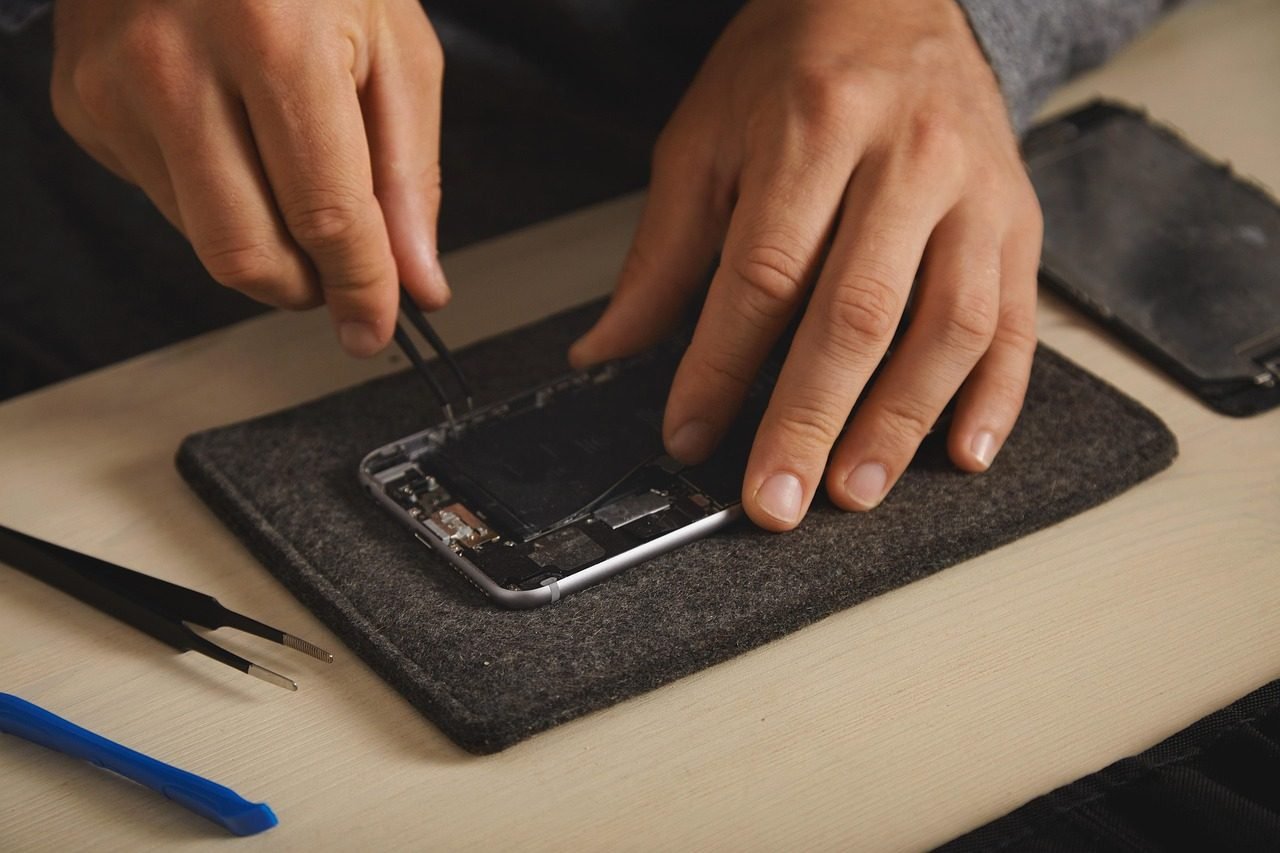 Technician repairing a smartphone at Gadget Care, Island Bay