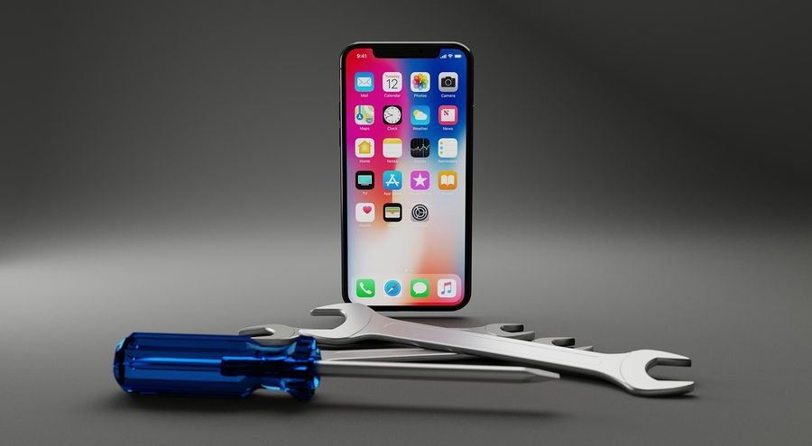 iPhone beside a screwdriver and spanners