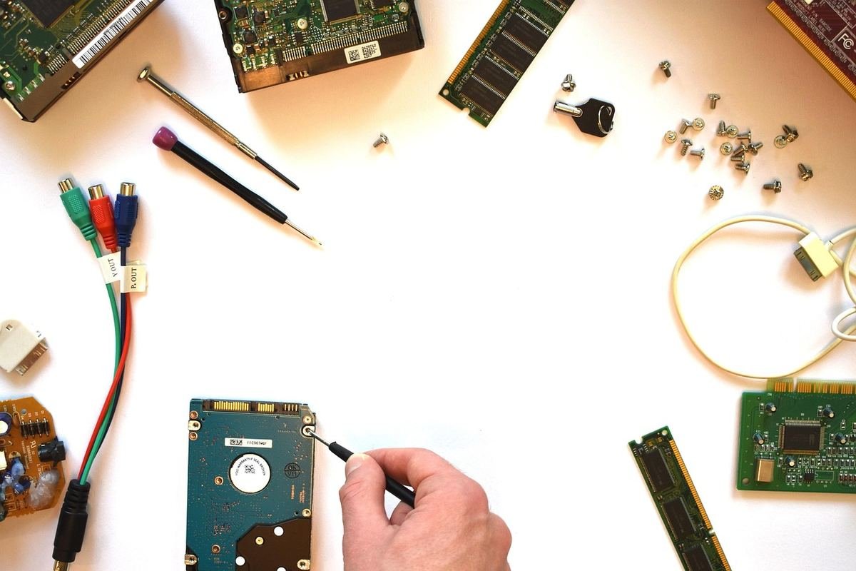 Laptop components and tools laid out on a workbench